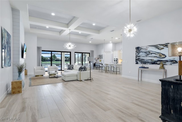 living room with beam ceiling, light hardwood / wood-style flooring, coffered ceiling, and an inviting chandelier