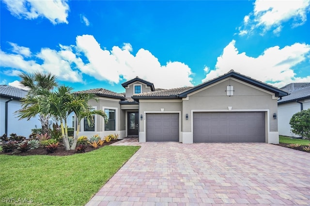 view of front of property with a garage and a front lawn