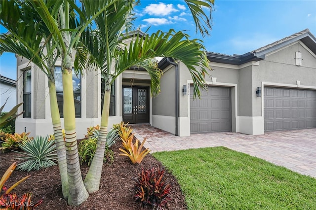 view of front of property with french doors and a garage