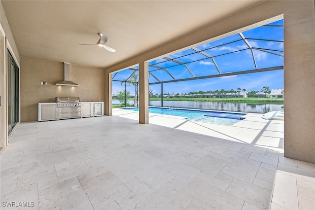 view of swimming pool with glass enclosure, grilling area, an outdoor kitchen, a water view, and ceiling fan