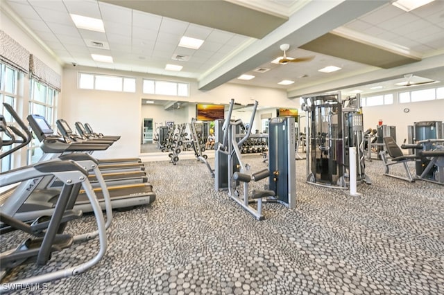 exercise room with a paneled ceiling and ceiling fan