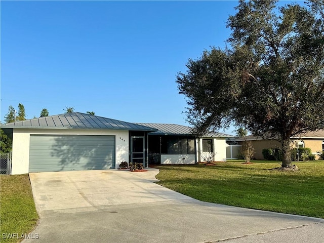 ranch-style house with a sunroom, a front lawn, and a garage