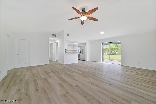 unfurnished living room featuring light wood-type flooring, ceiling fan, and vaulted ceiling