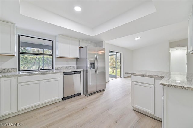 kitchen with sink, white cabinetry, a raised ceiling, and appliances with stainless steel finishes