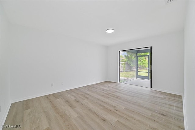 empty room with light hardwood / wood-style floors