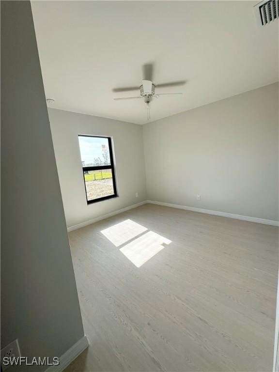 unfurnished room with ceiling fan and light hardwood / wood-style flooring