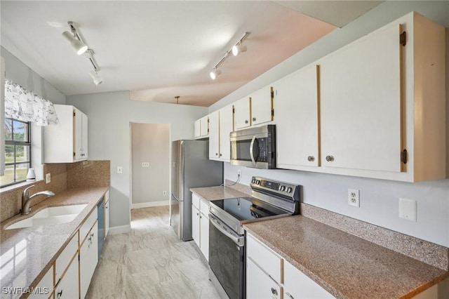 kitchen featuring white cabinets, stainless steel appliances, and sink