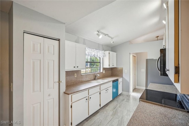 kitchen featuring dishwasher, sink, backsplash, lofted ceiling, and white cabinets