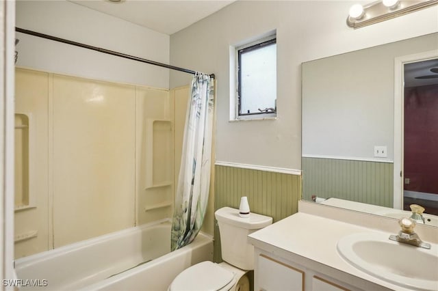 full bathroom with shower / bath combo, wood walls, toilet, and vanity