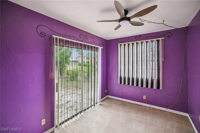 carpeted spare room with ceiling fan