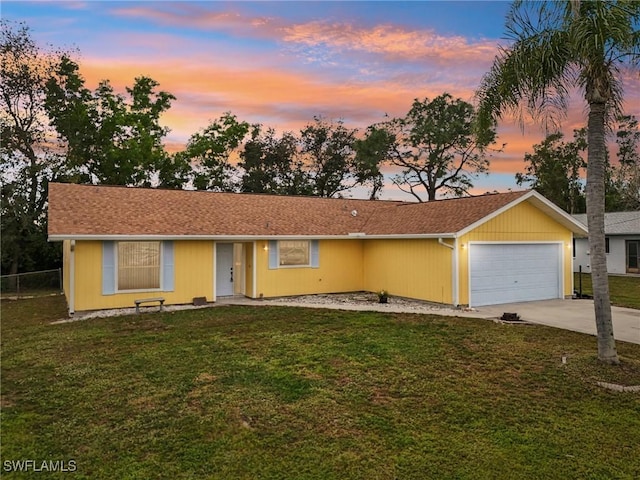 single story home featuring a yard and a garage