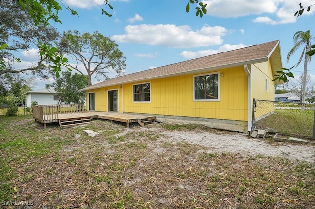 back of property with a wooden deck