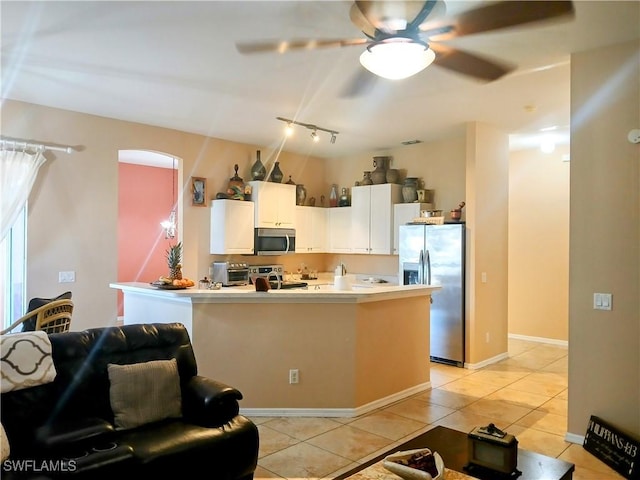 kitchen with white cabinetry, light tile patterned floors, stainless steel appliances, and ceiling fan