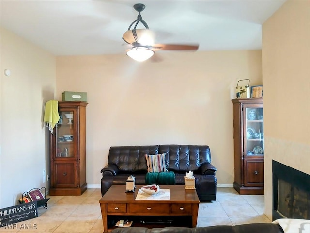 tiled living room featuring ceiling fan