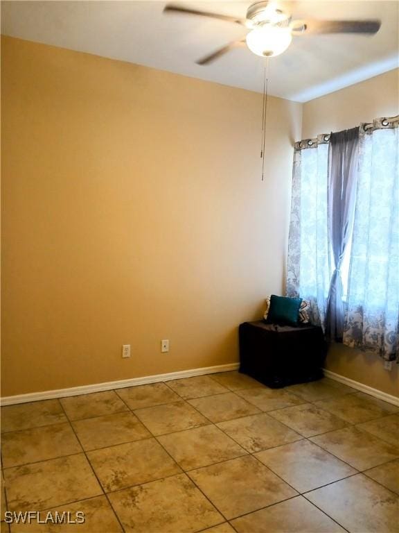 empty room with tile patterned floors and ceiling fan