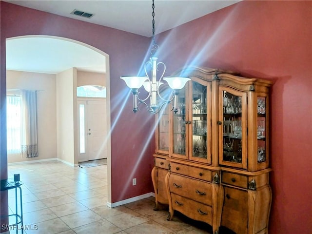 interior space featuring tile patterned floors and an inviting chandelier