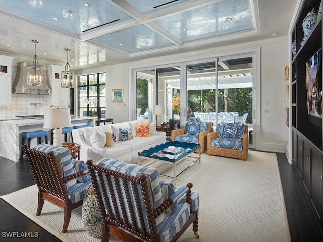 living room with a chandelier, beam ceiling, crown molding, and coffered ceiling