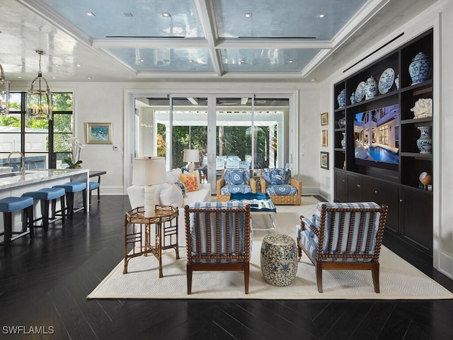 living room with a healthy amount of sunlight, ornamental molding, sink, and coffered ceiling