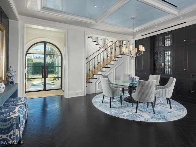 dining area featuring a notable chandelier, dark parquet floors, ornamental molding, and coffered ceiling