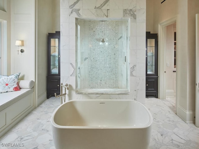 bathroom with a washtub and vanity