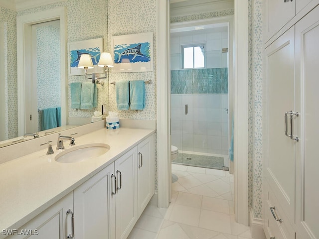 bathroom featuring tile patterned floors, vanity, toilet, and a shower with door