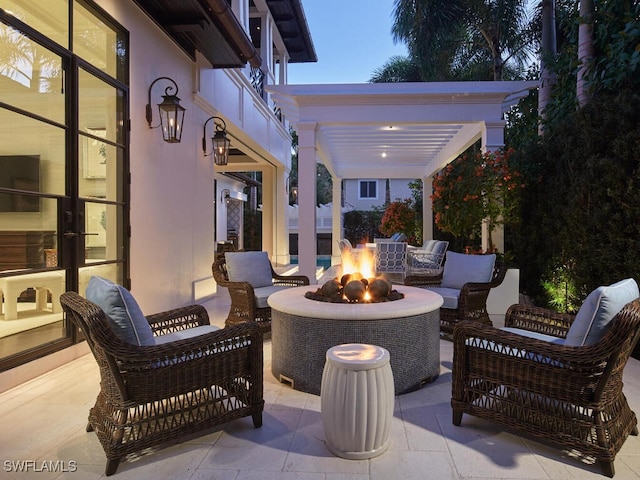 view of patio featuring an outdoor living space with a fire pit