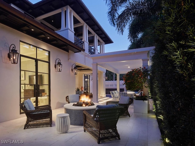 view of patio / terrace featuring a fire pit and a balcony