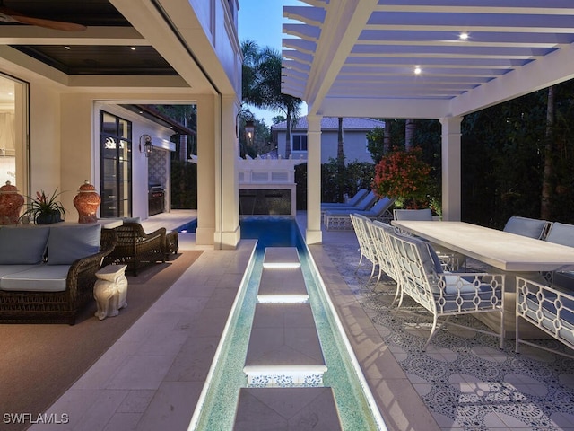 patio terrace at dusk with a pergola and outdoor lounge area