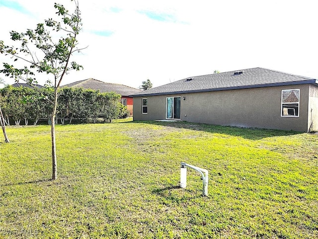 back of house featuring a yard