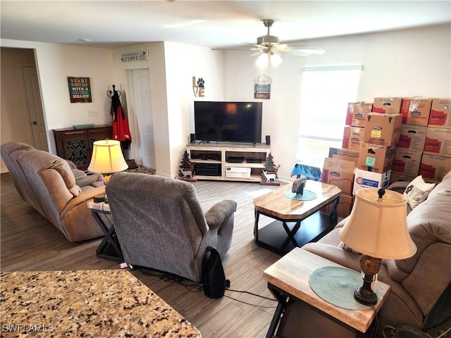 living room featuring ceiling fan and wood-type flooring