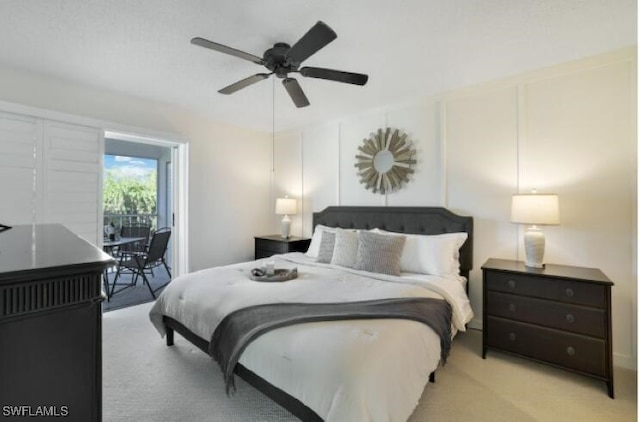 carpeted bedroom with access to outside and ceiling fan