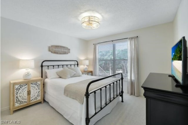 carpeted bedroom featuring a textured ceiling