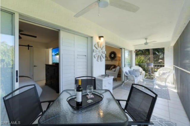 sunroom / solarium featuring a barn door