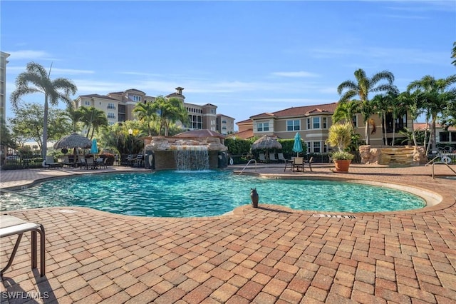 view of pool featuring pool water feature and a patio area