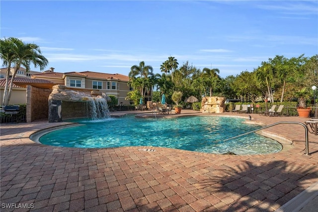 view of pool featuring pool water feature and a patio