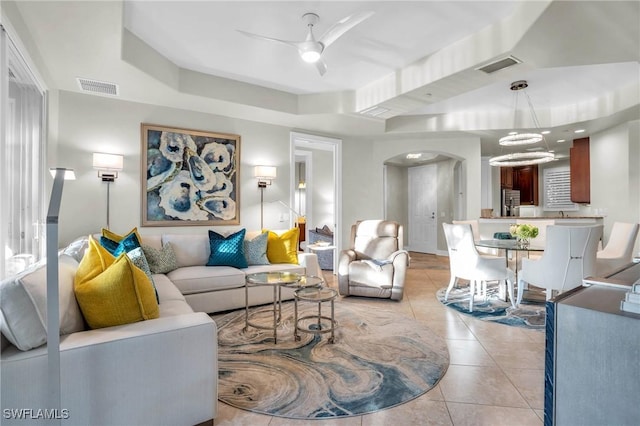 tiled living room featuring ceiling fan