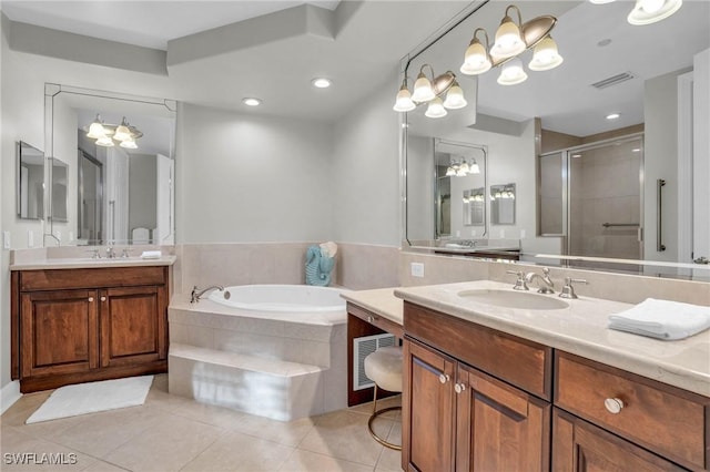 bathroom with tile patterned flooring, vanity, a chandelier, and independent shower and bath