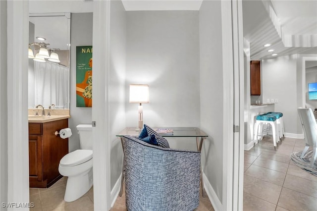 bathroom featuring tile patterned flooring, vanity, and toilet