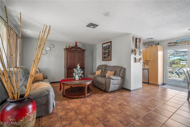 living room with tile patterned floors and a textured ceiling