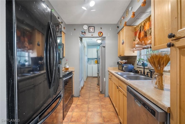 kitchen featuring sink, light tile patterned floors, black appliances, and light brown cabinets