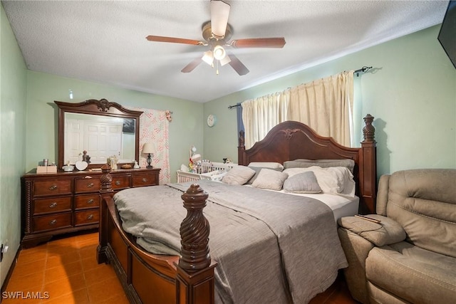 bedroom with a textured ceiling and ceiling fan