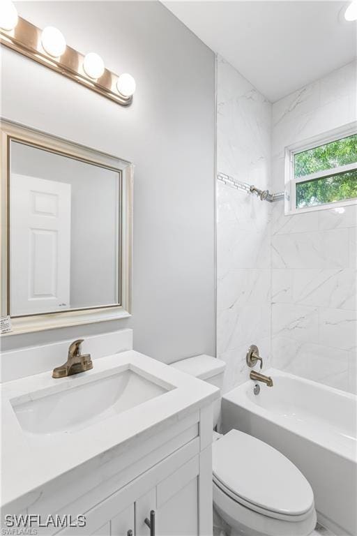 full bathroom featuring vanity, toilet, and tiled shower / bath combo