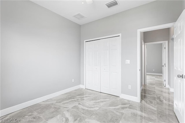 unfurnished bedroom with a closet and ceiling fan