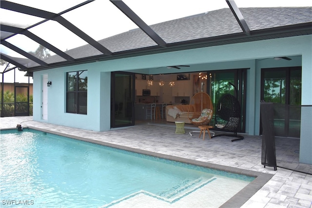 view of pool featuring a patio, a lanai, and ceiling fan