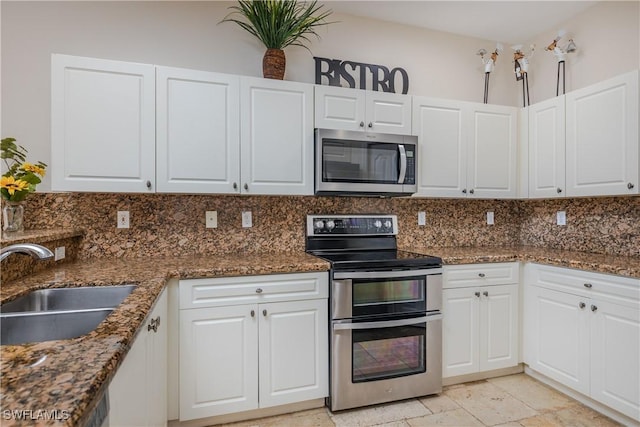 kitchen with white cabinetry, stainless steel appliances, sink, and backsplash