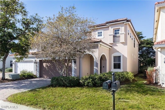 mediterranean / spanish-style house with a front yard