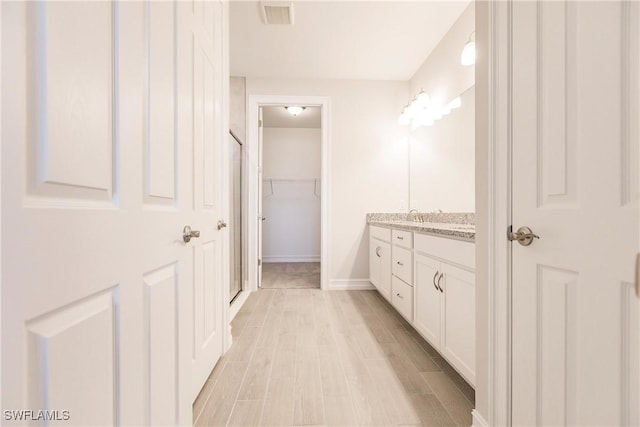 bathroom featuring vanity and hardwood / wood-style flooring