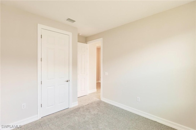 unfurnished bedroom with light colored carpet