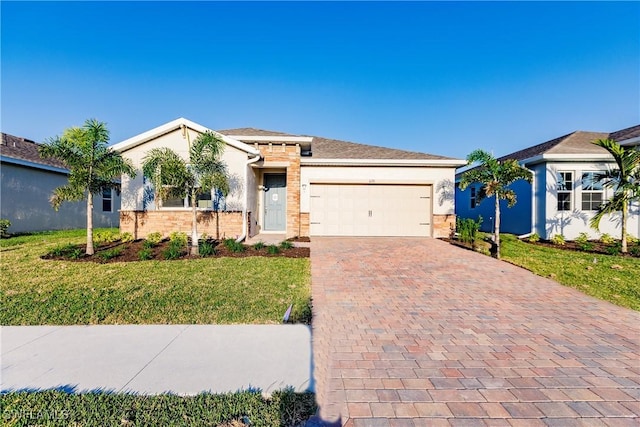 view of front of home with a front yard and a garage