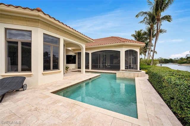 rear view of house featuring a patio area and a sunroom